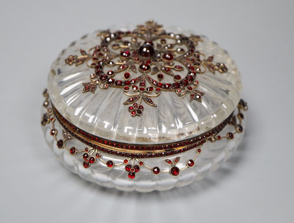 A Victorian yellow metal, cabochon and facet cut garnet mounted circular fluted glass powder jar, diameter 10.7cm.